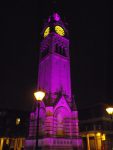 Clock tower floodlit purple